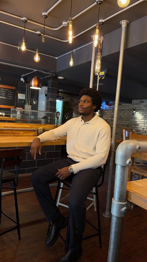 John Udoumoh seated in a café in Coventry